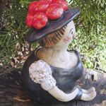 TF1002 Tonfigur Schwarzw&auml;lderin sitzend mit rotem Bollenhut