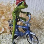 GLF2009 Glücksfrosch Fahrradfahrer mit blauem Fahrrad und großem Bollenhut